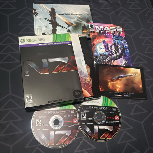 Image shows the cases, extras and two discs for the N7 Collector's Edition of the video game Mass Effect 3 for Xbox 360