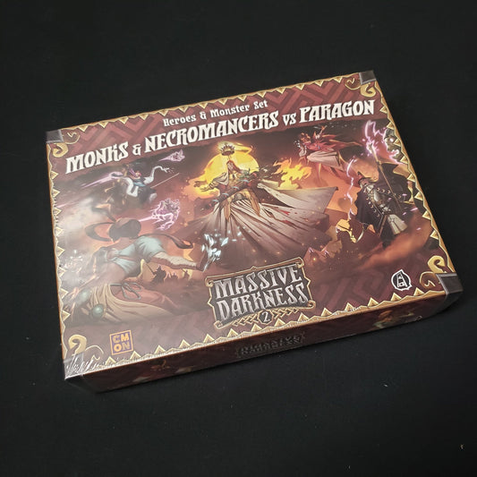 Image shows the front cover of the box of the Monks & Necromancers vs Paragon expansion for the board game Massive Darkness 2: Hellscape