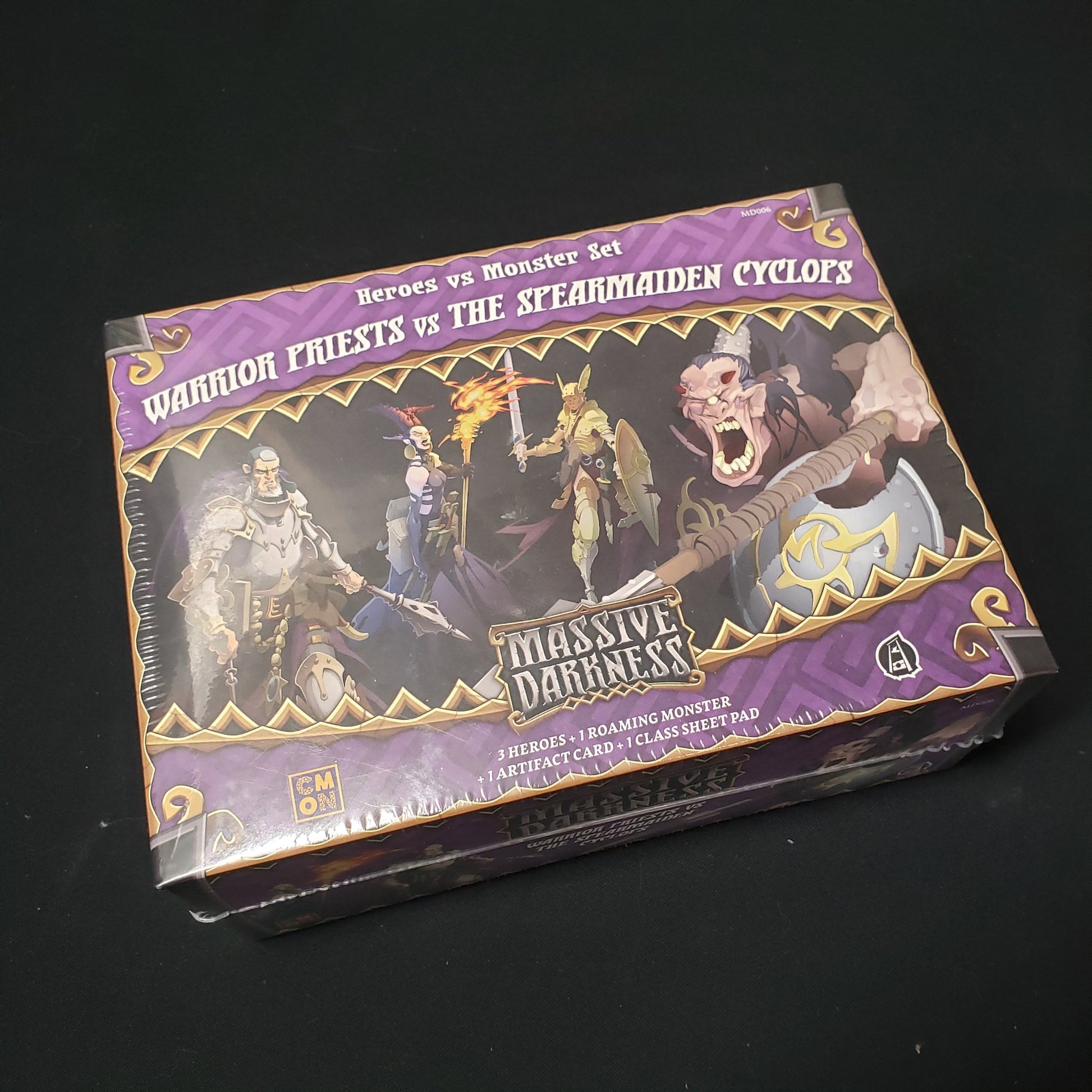 Image shows the front cover of the box of the Warriors Priests vs the Spearmaiden Cyclops expansion for the board game Massive Darkness