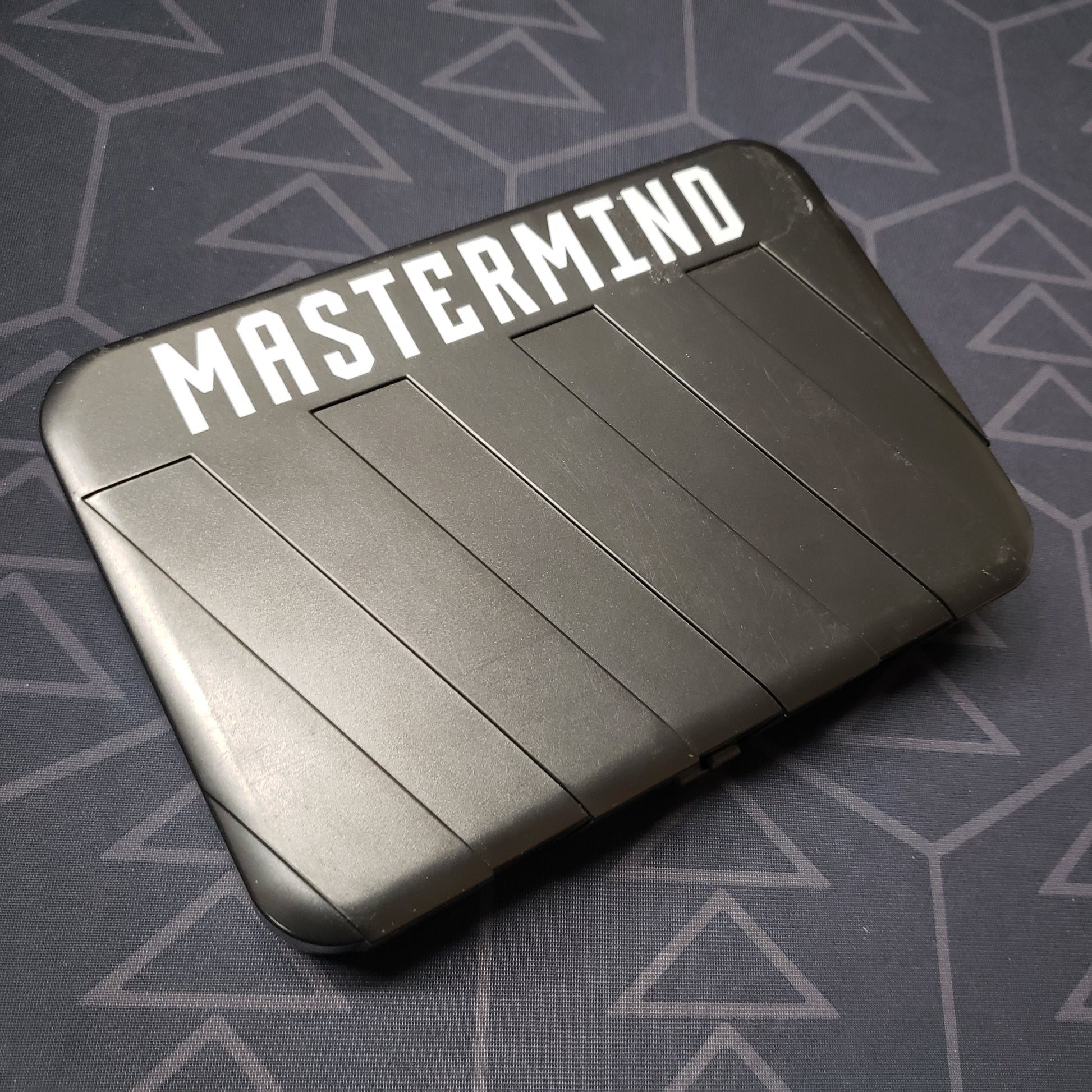 Image shows the front of the case for the Mastermind: Travel Edition board game