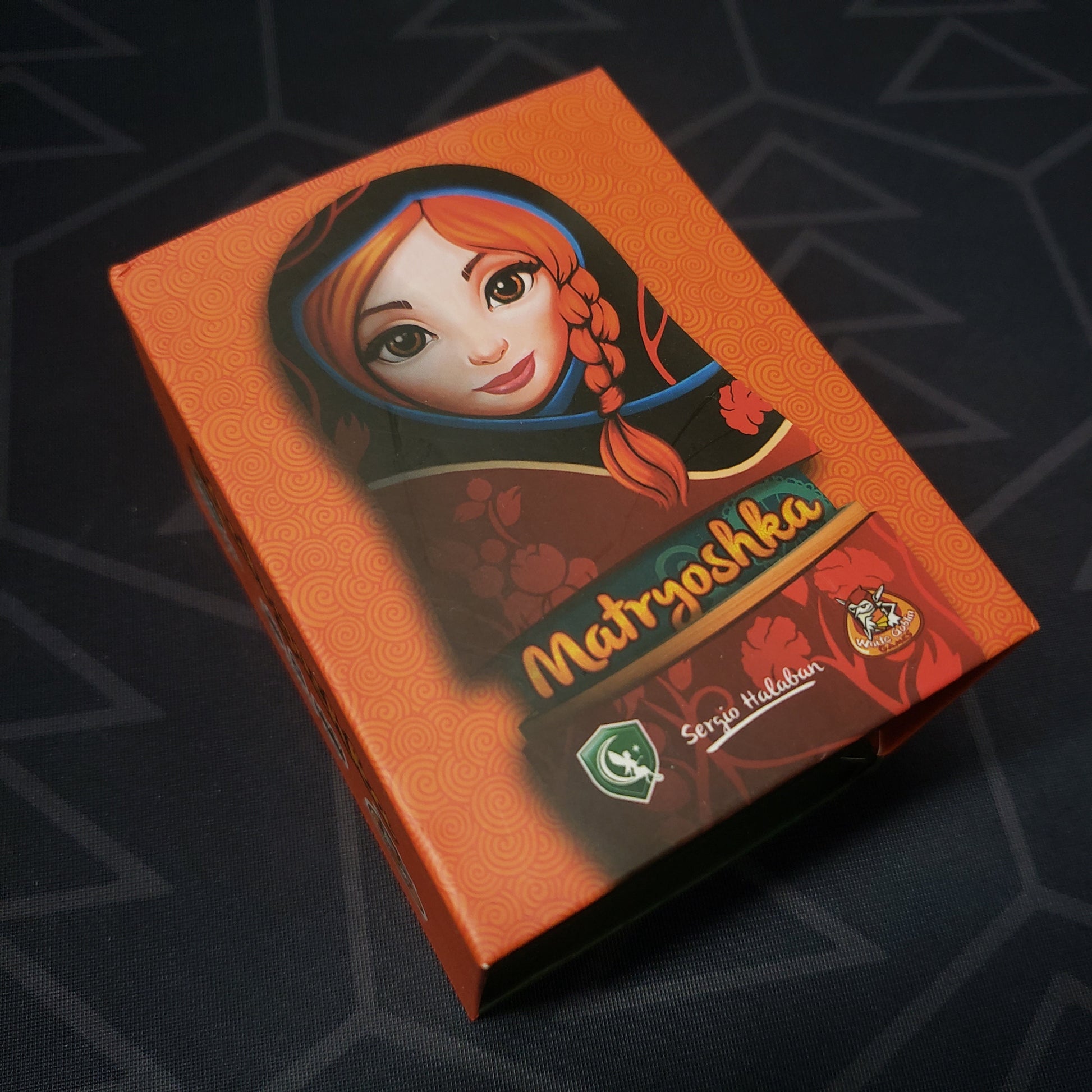 Image shows the front cover of the box for the Matryoshka card game