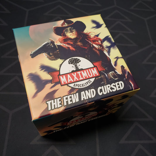 Image shows the front cover of the box of the The Few and the Cursed expansion for the card game Maximum Apocalypse