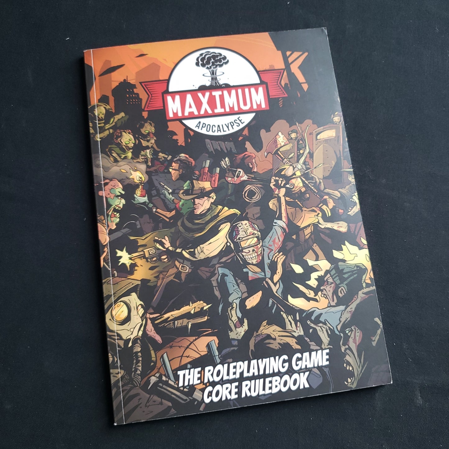 Image shows the front cover of the Core Rulebook for the Maximum Apocalypse roleplaying game