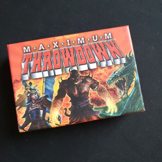 Image shows the front cover of the box of the Maximum Throwdown card game