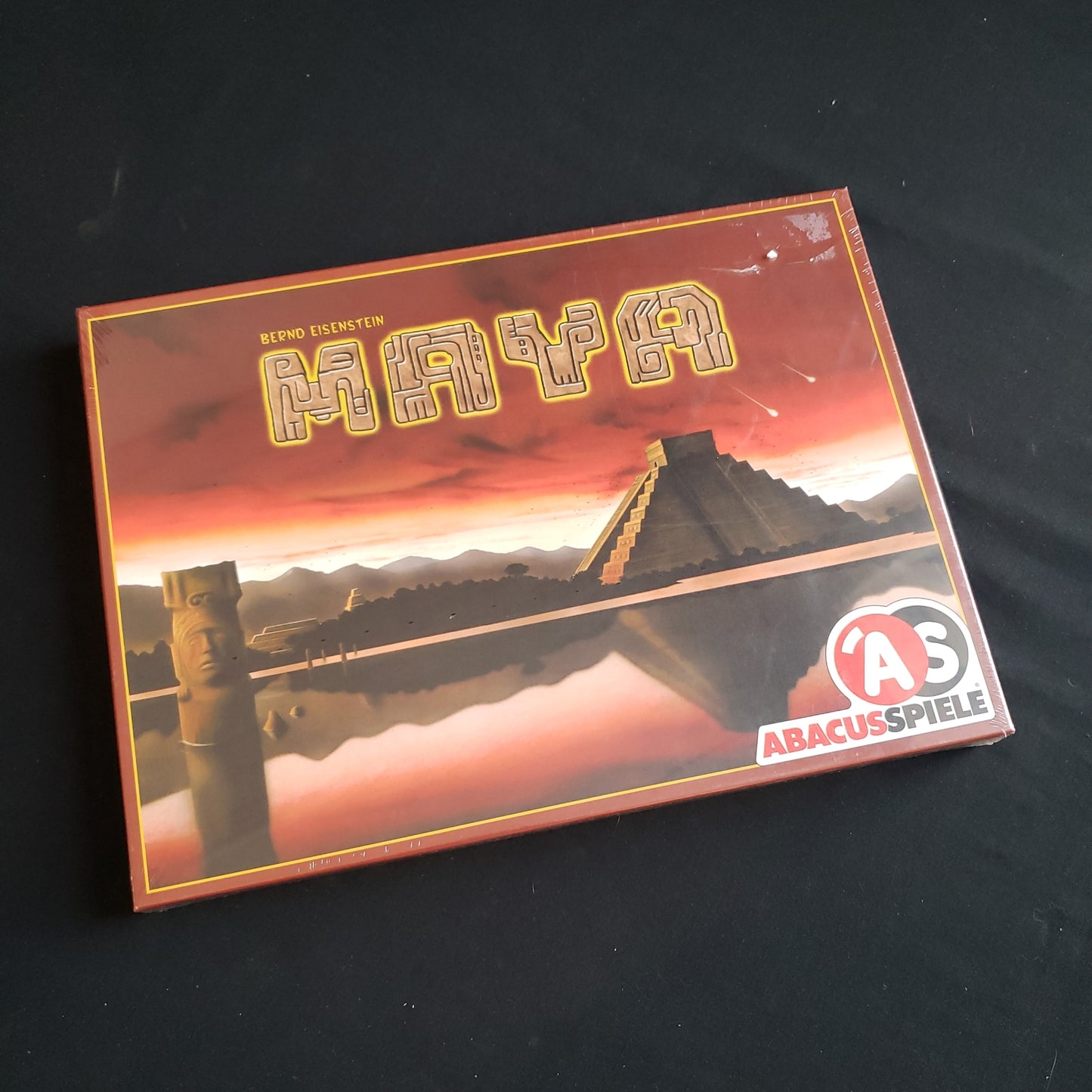 Image shows the front cover of the box of the Maya board game
