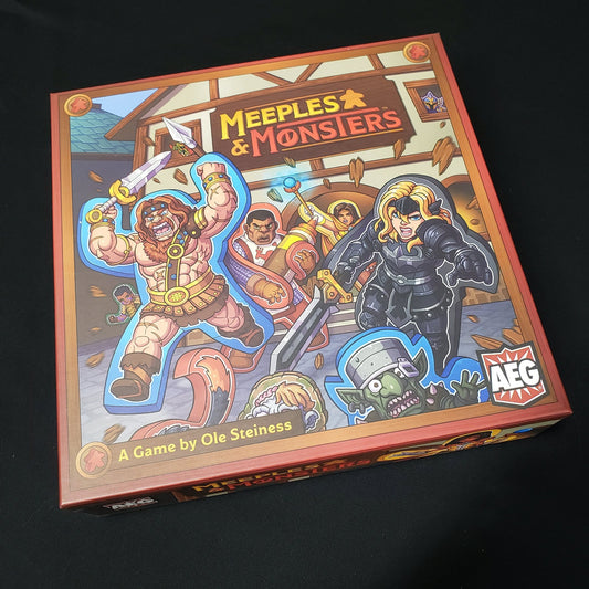 Image shows the front cover of the box of the Meeples & Monsters board game