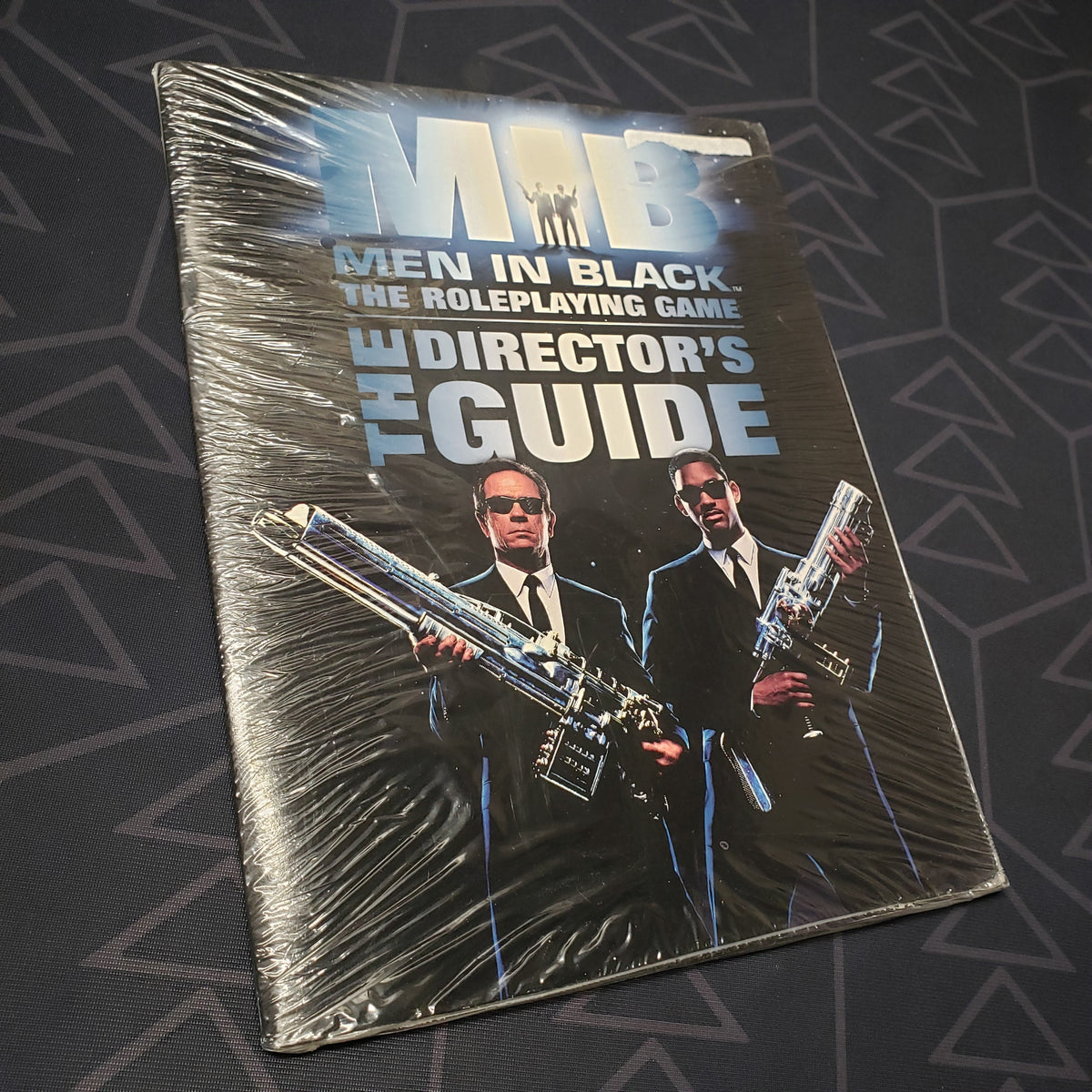 Image shows the front cover of the Director's Guide book for the roleplaying game Men in Black