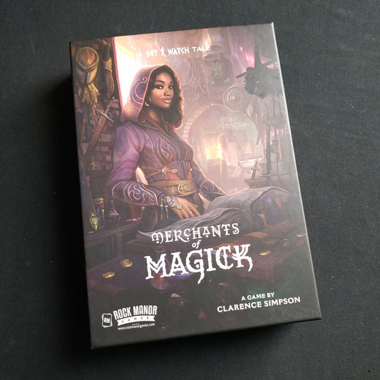 Image shows the front cover of the box of the Merchants of Magick board game
