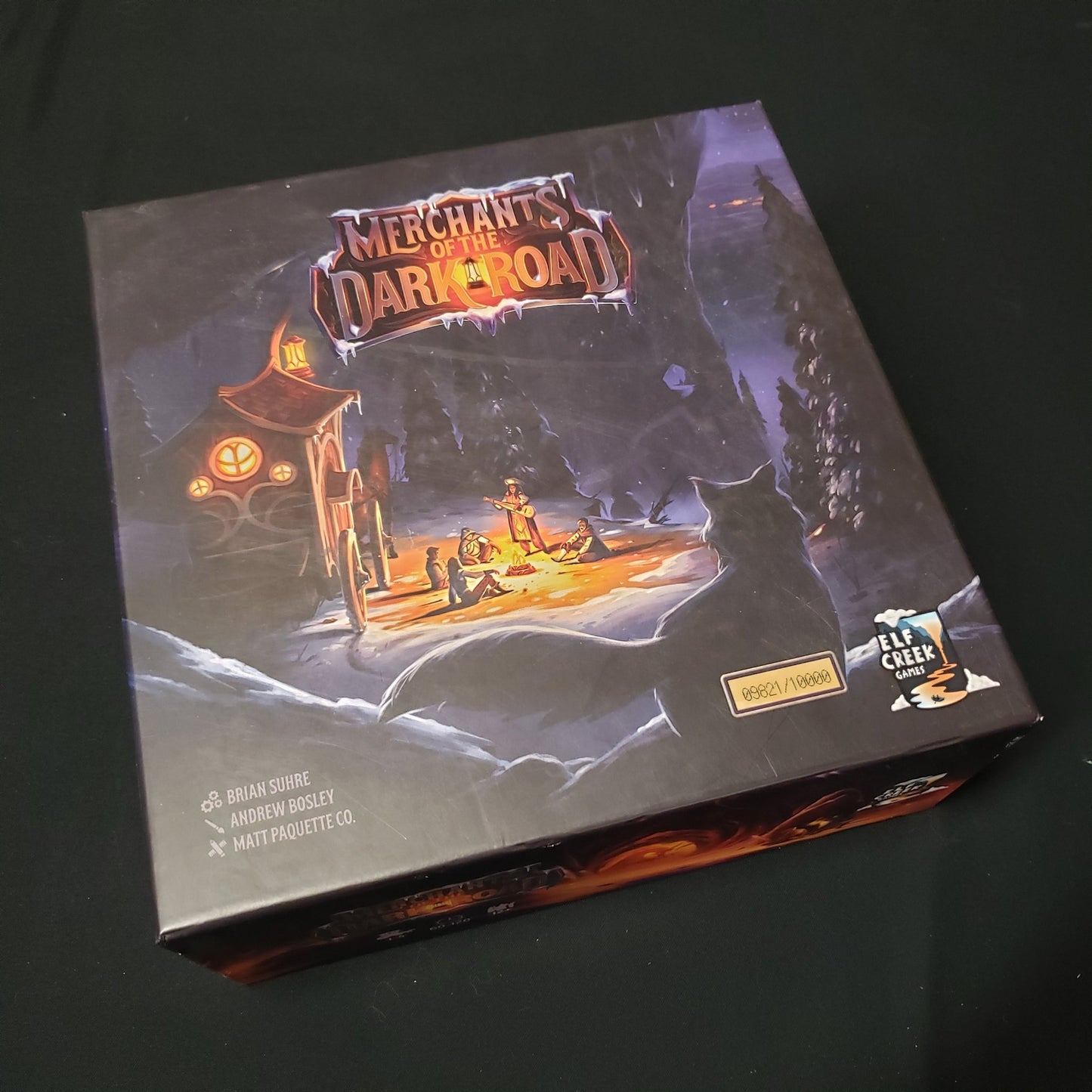 Image shows the front cover of the box of the Merchants of the Dark Road board game