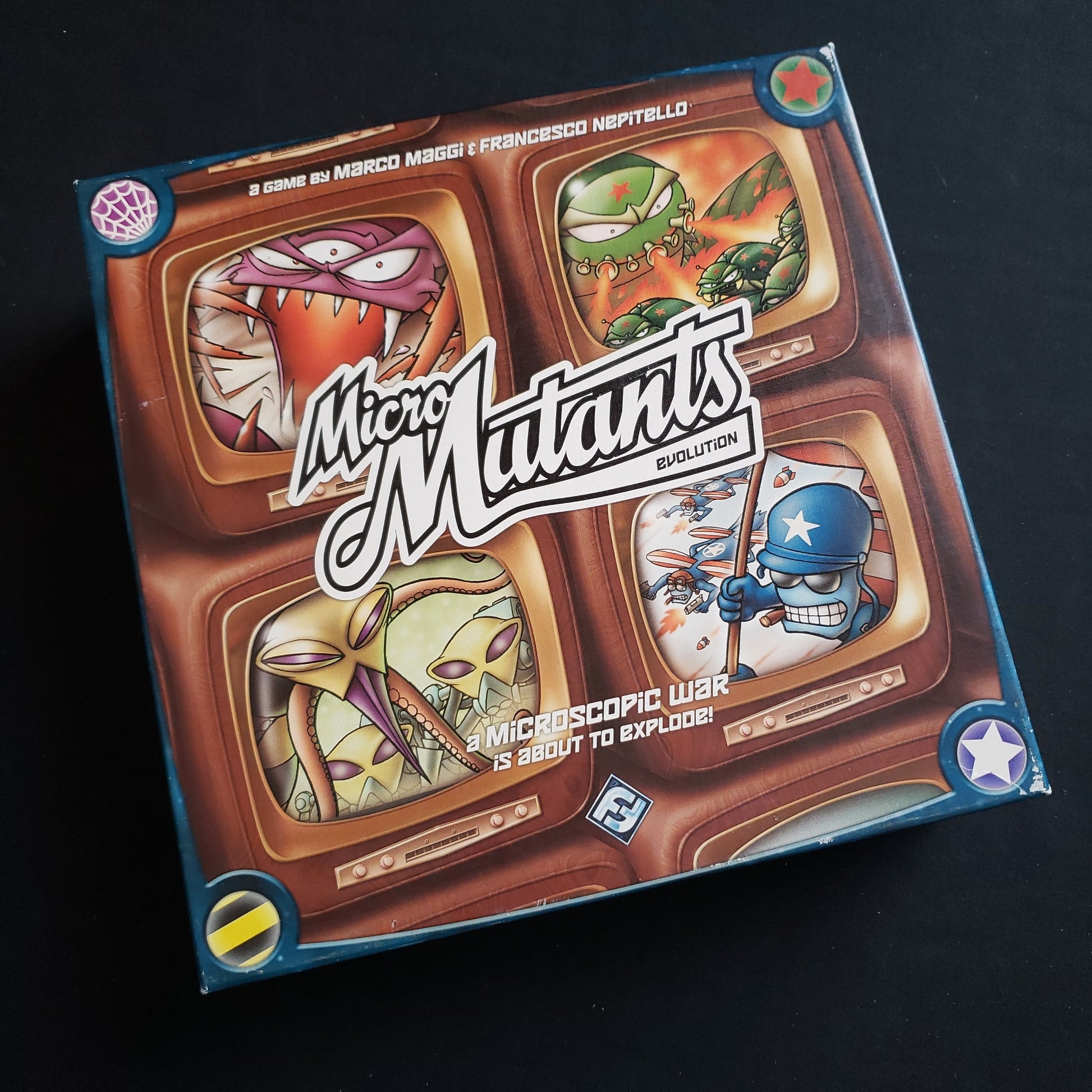 Image shows the front cover of the box of the Micro Mutants: Evolution board game