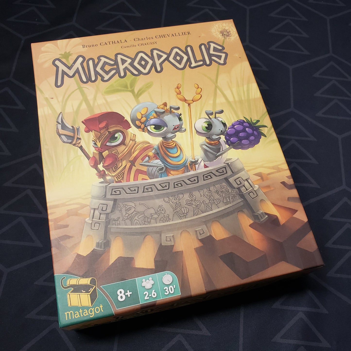 Image shows the front cover of the box for the Micropolis board game