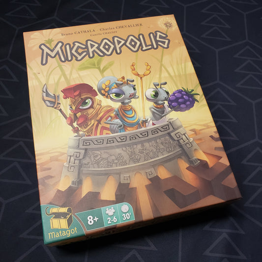 Image shows the front cover of the box for the Micropolis board game