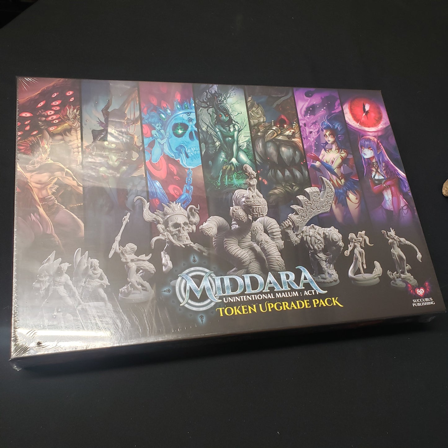 Image shows the front cover of the box of the Act 1 Token Upgrade Pack for the board game Middara