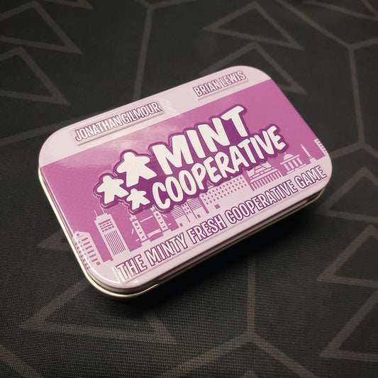 Image shows the front cover of the tin for the Mint Cooperative board game