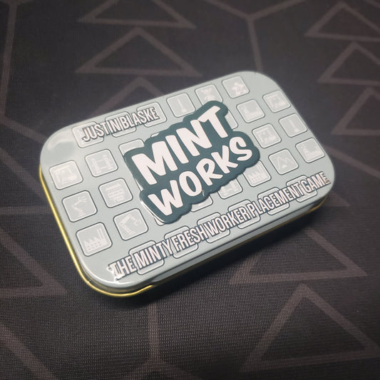 Image shows the front cover of the box for the Mint Works board game