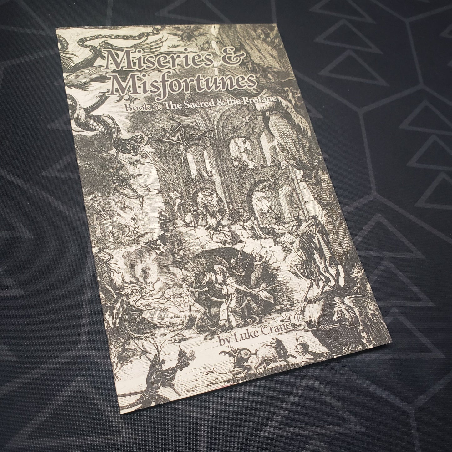 Image shows the front cover of the Sacred & the Profane book for the roleplaying game Miseries & Misfortunes