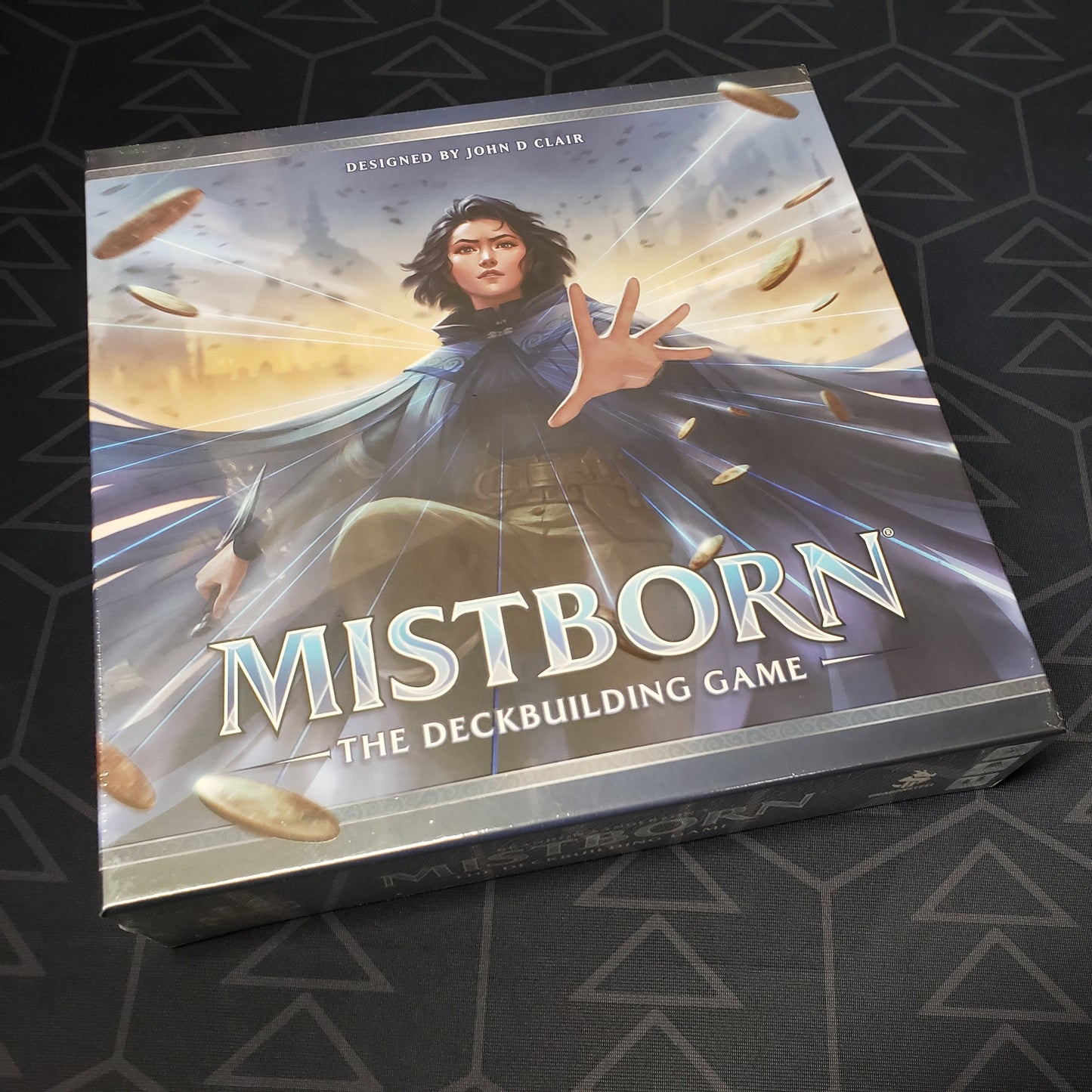 Image shows the front cover of the box of Mistborn: The Deckbuilding Game