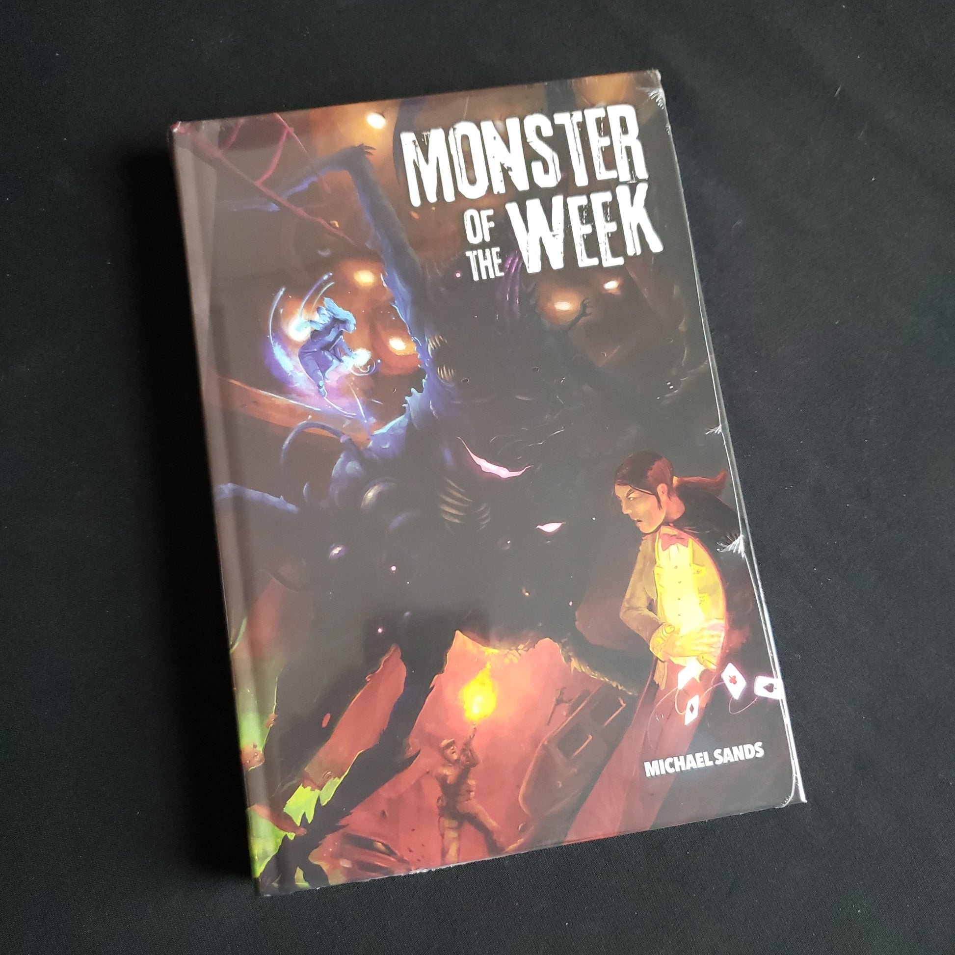 Image shows the front cover of the hardcover edition of the Monster of the Week roleplaying game book