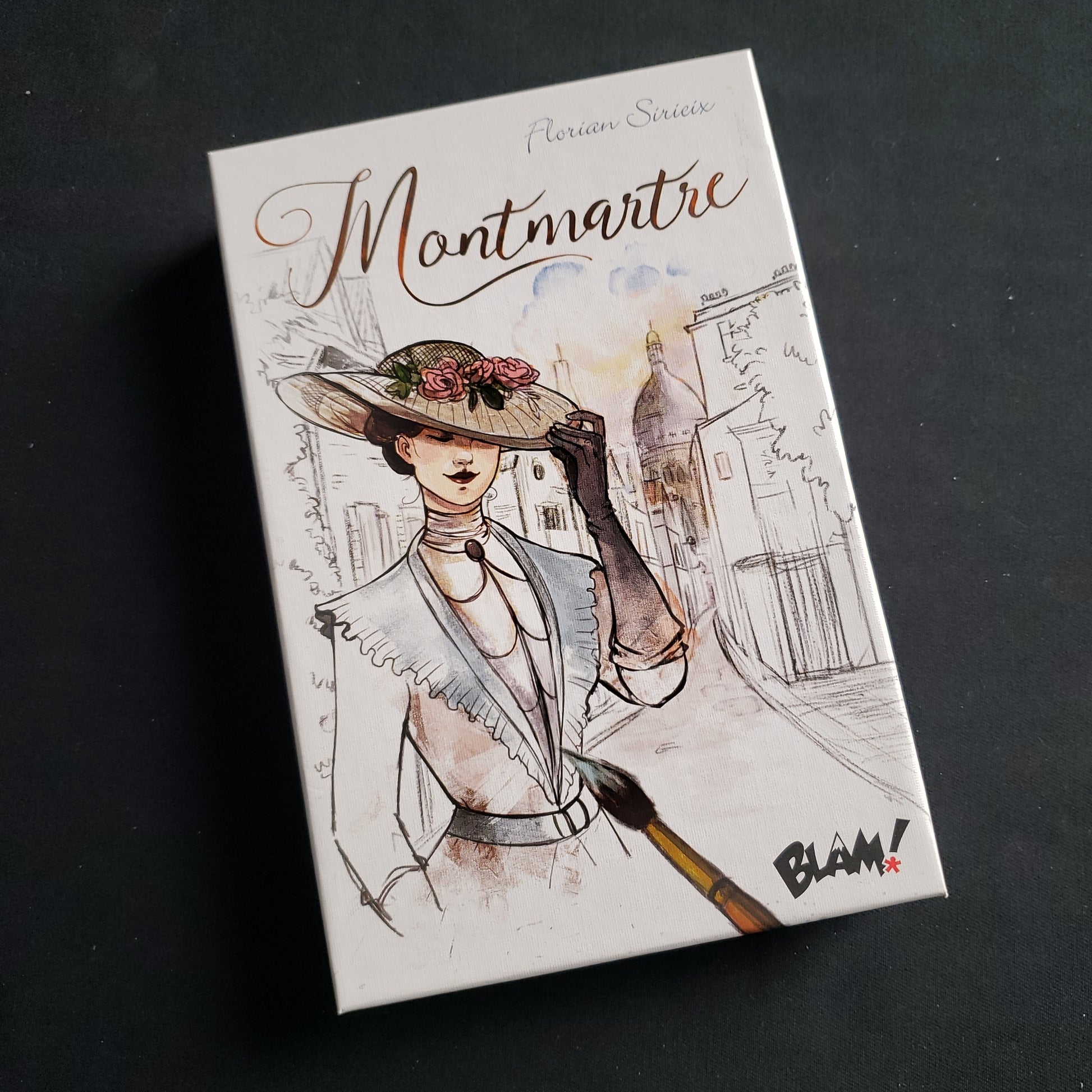 Image shows the front cover of the box of the Montmartre card game