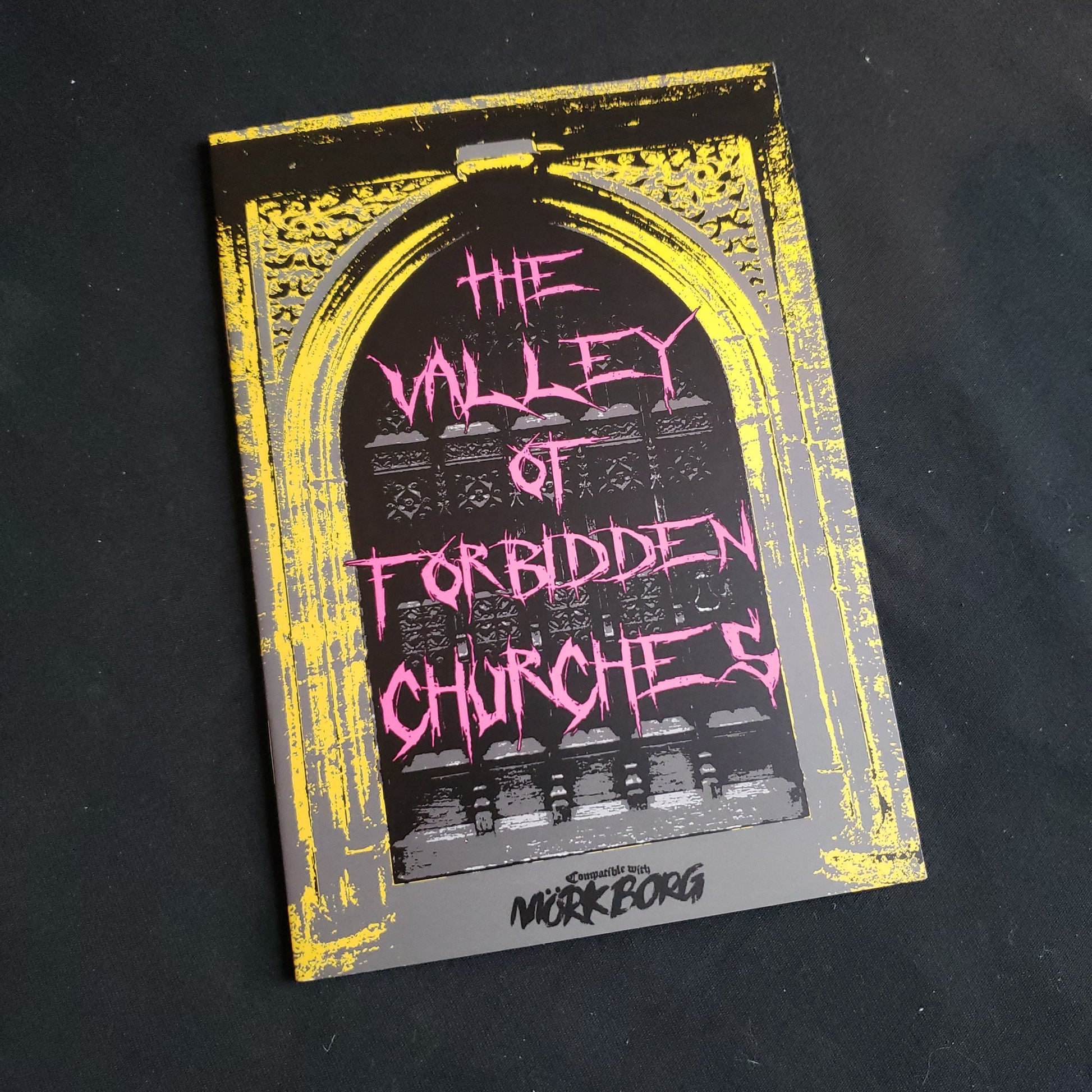 Image shows the front cover of the Valley of Forbidden Churches book for the Mork Borg roleplaying game