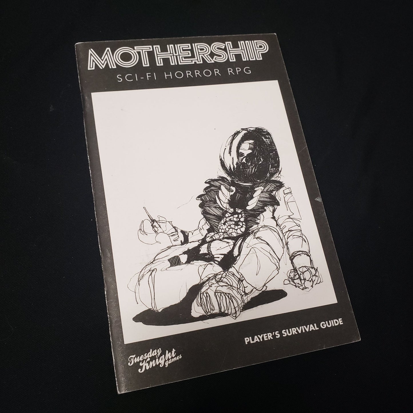 Image shows the front cover of the Mothership Sci-fi Horror RPG Player's Survival Guide