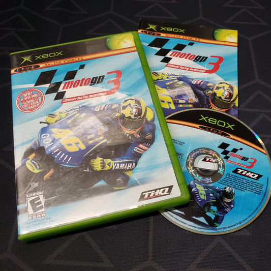 Image shows the case, manual and disc for the video game MotoGP 3: Ultimate Racing Technology for the original Xbox