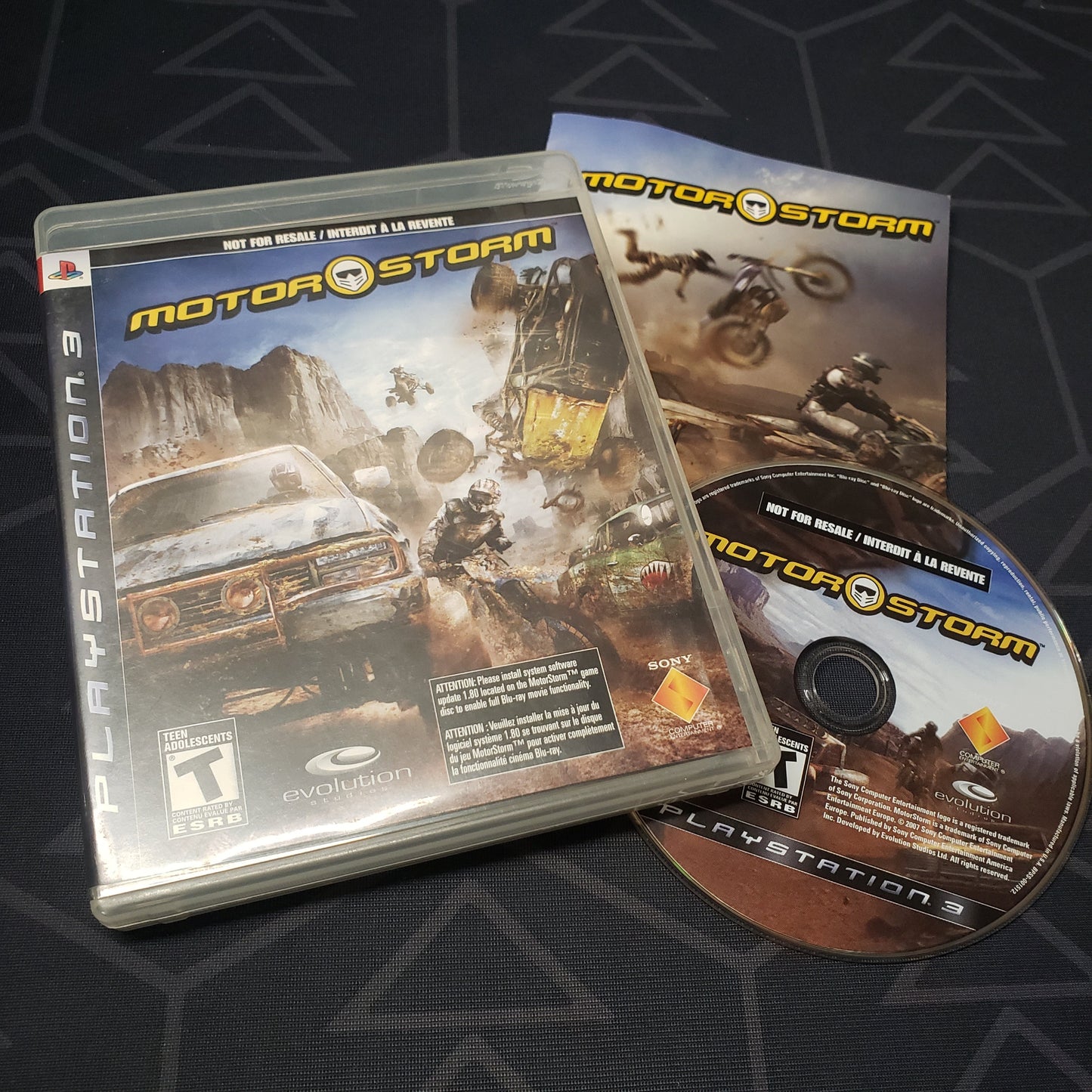 Image shows the case, manual and disc for the video game MotorStorm for Playstation 3