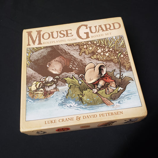 Image shows the front cover of the box of the second edition boxed set for the Mouse Guard roleplaying game