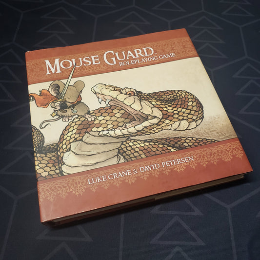Image shows the front cover of the core rulebook for the roleplaying game Mouse Guard (Second Edition)