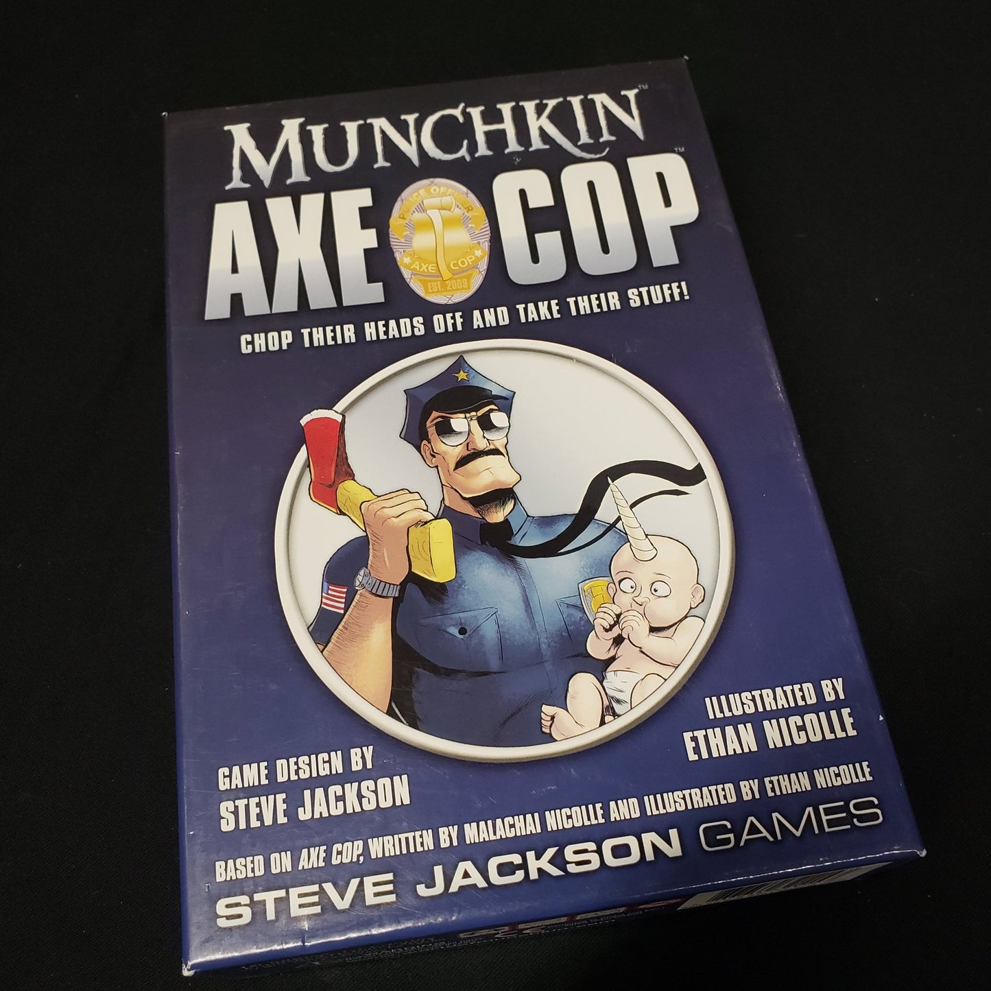 Image shows the front cover of the box of the Munchkin Axe Cop card game