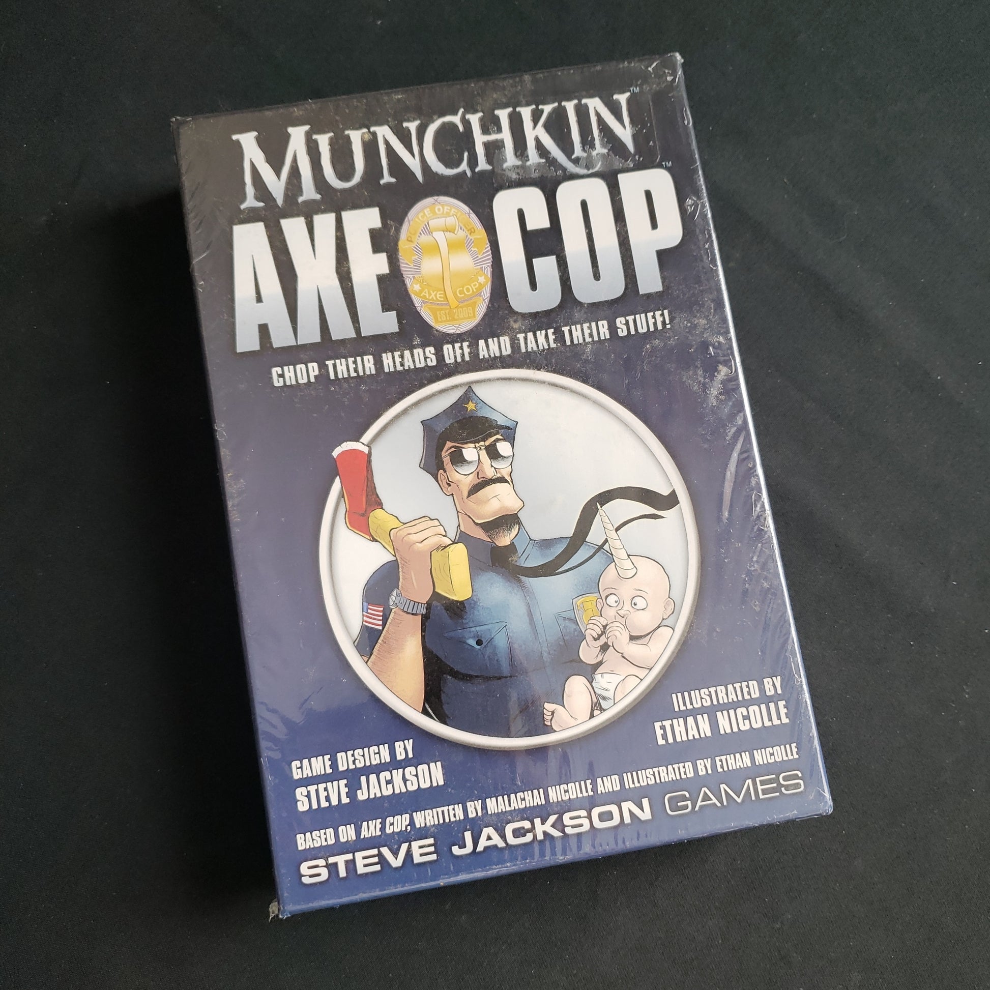 Image shows the front cover of the box of the Munchkin Axe Cop card game