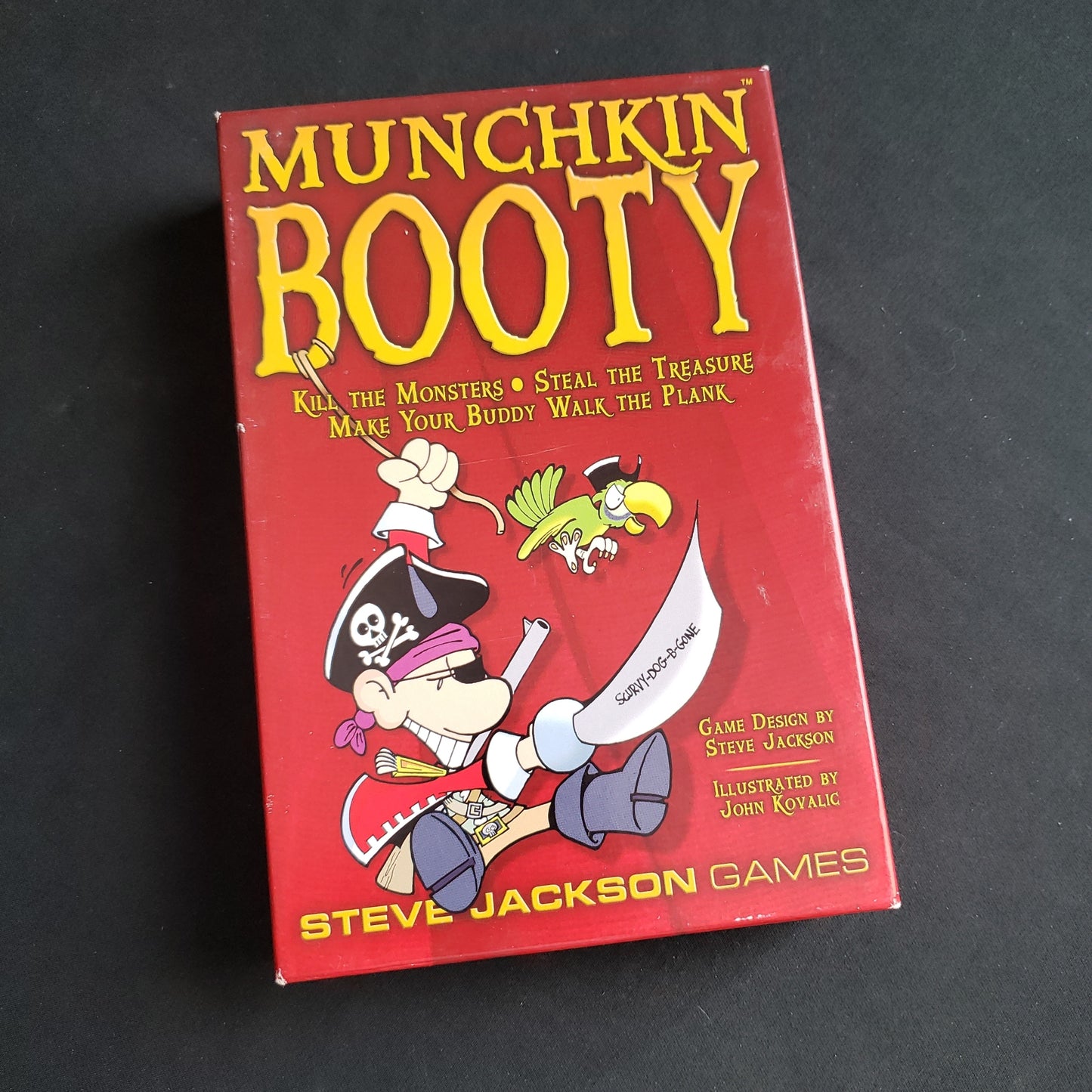 Image shows the front cover of the box of the Munchkin Booty card game