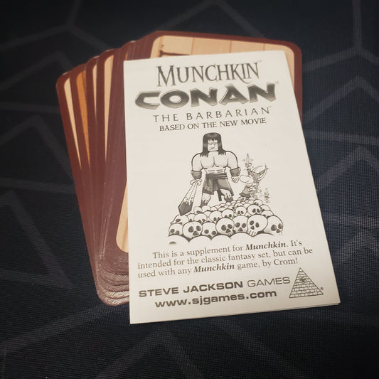 Image shows the cards & instructions for the Conan the Barbarian Booster Pack for the card game Munchkin