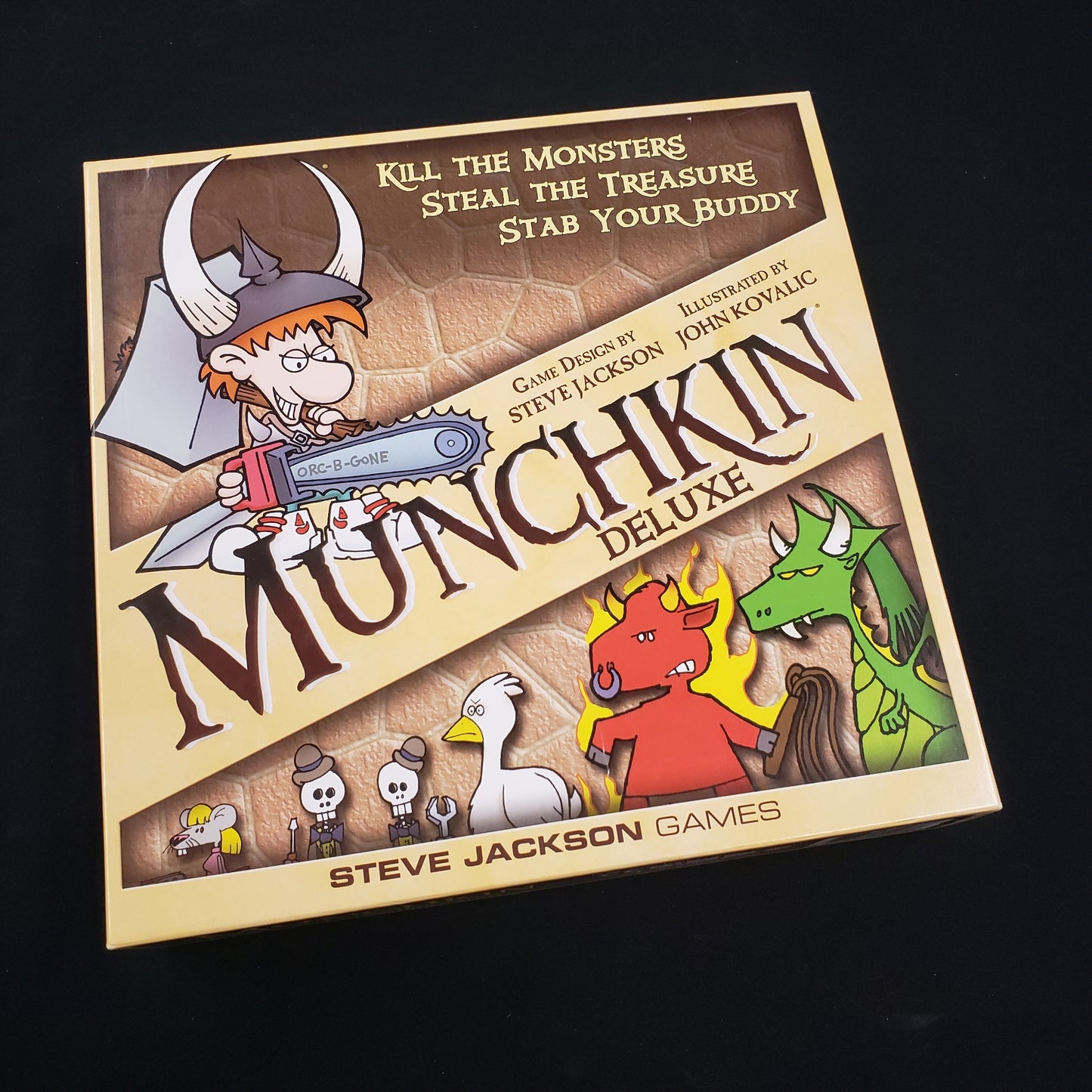 Image shows the front cover of the box of the Munchkin: Deluxe Edition card game