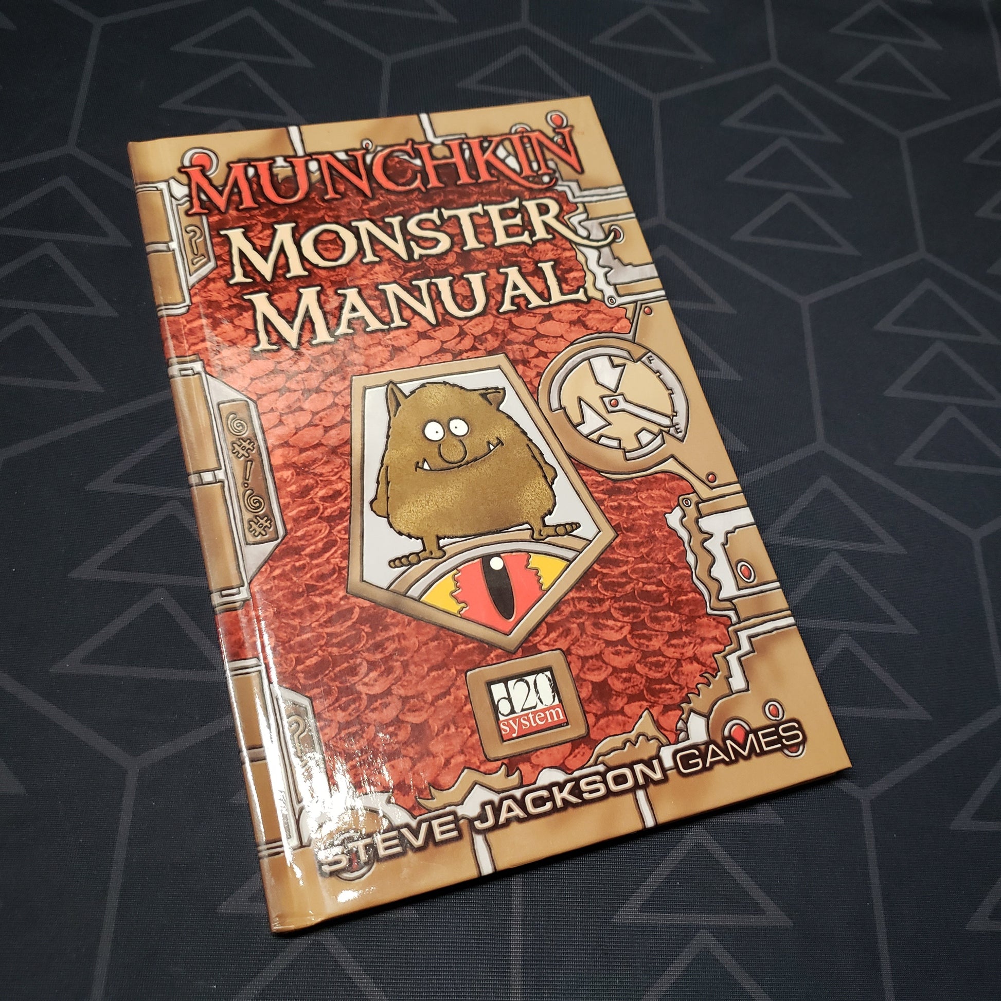 Image shows the front cover of the Munchkin: Monster Manual roleplaying game book