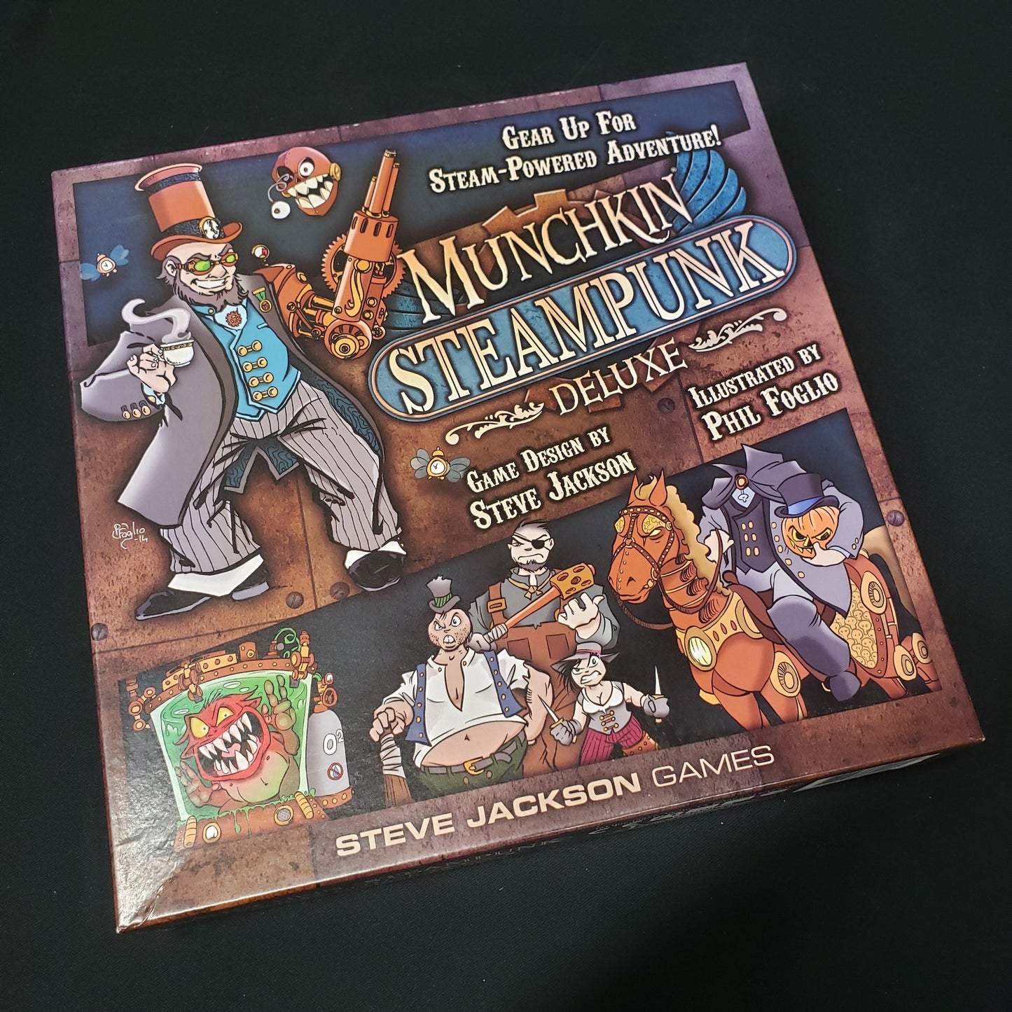 Image shows the front cover of the box of the Munchkin Steampunk Deluxe card game