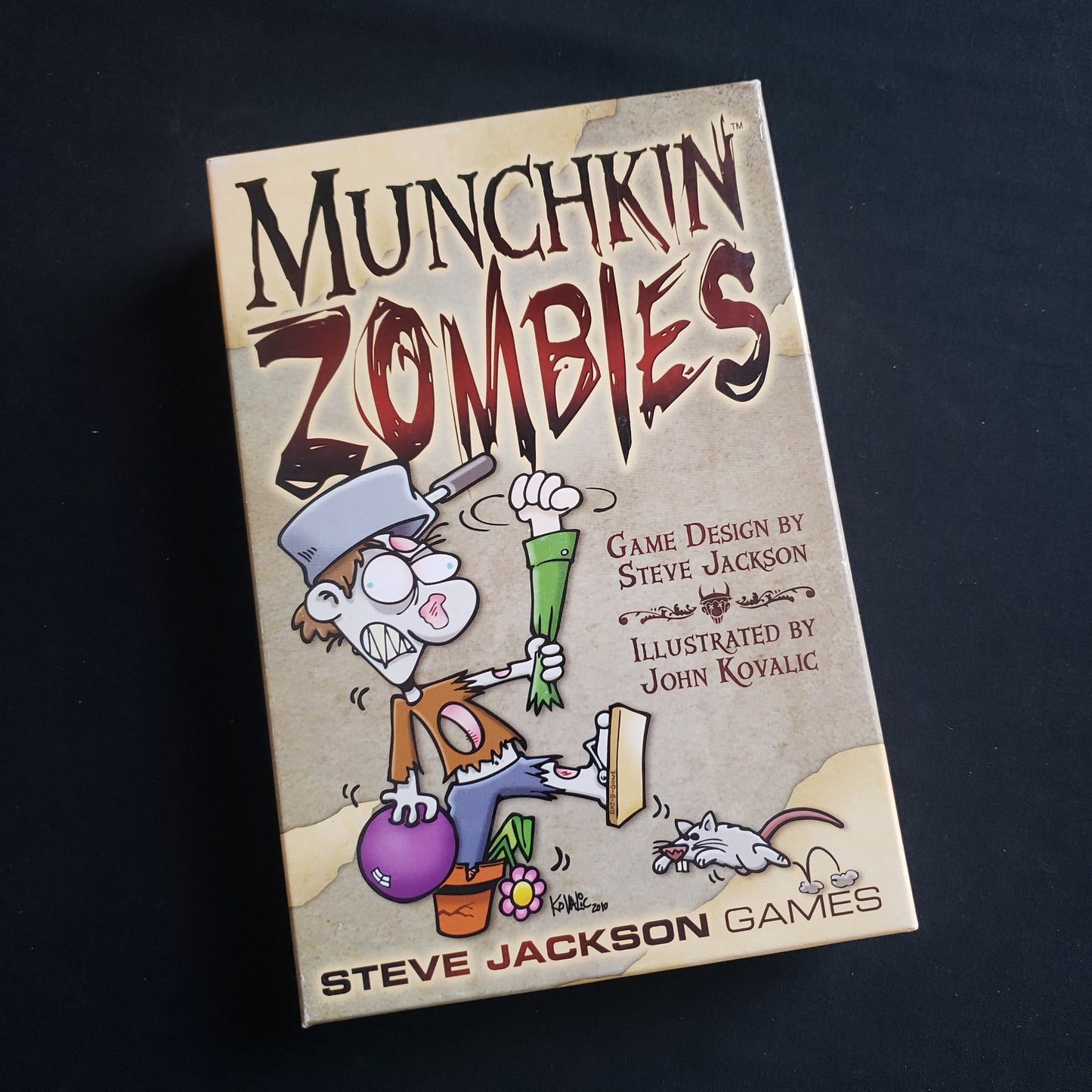 Image shows the front cover of the box of the Munchkin Zombies card game