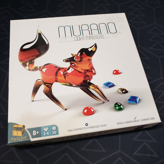 Image shows the front cover of the box of the Murano: Light Masters board game