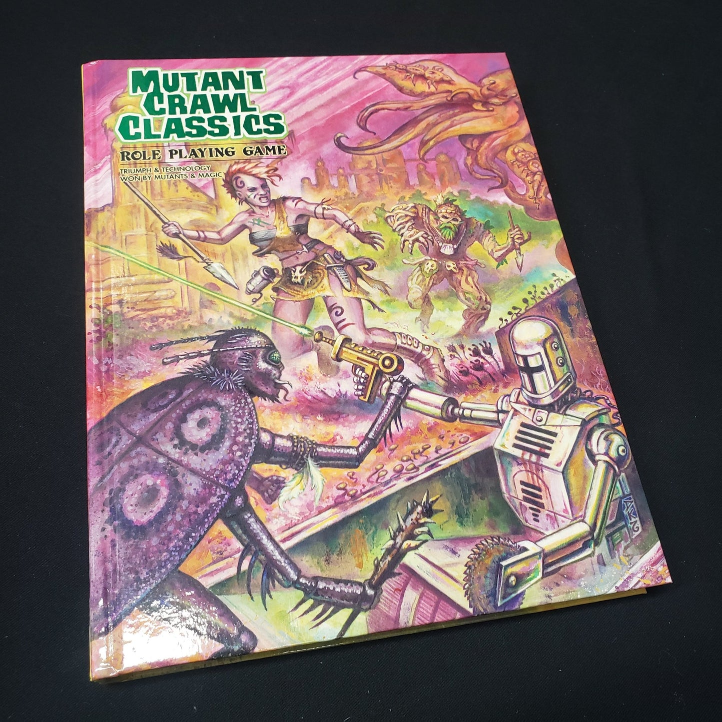 Image shows the front cover of the core rulebook for the roleplaying game Mutant Crawl Classics