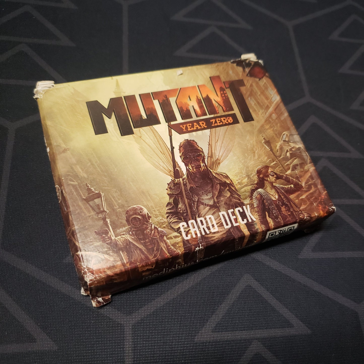 Image shows the front cover of the Card Deck box for the roleplaying game Mutant: Year Zero