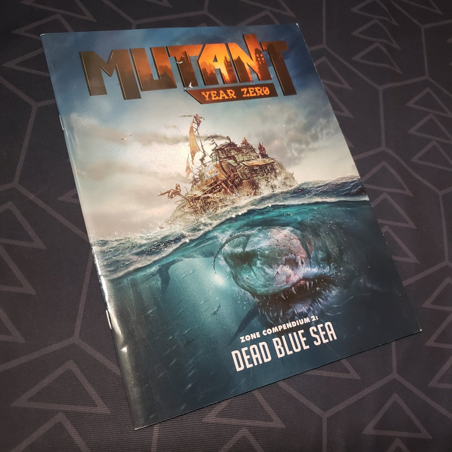 Image shows the front cover of the Zone Compendium 2: Dead Blue Sea book for the roleplaying game Mutant Year Zero