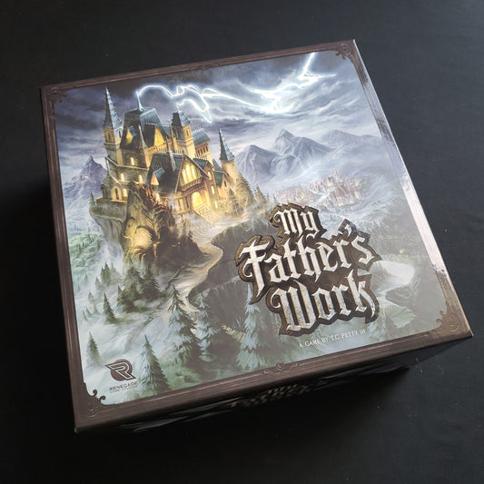Image shows the front cover of the box of the board game My Father's Work