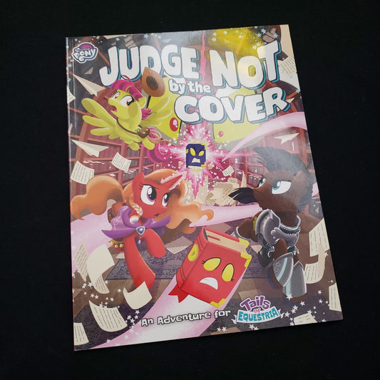 Image shows the front cover of the Judge Not by the Cover book for the My Little Pony: Tales of Equestria roleplaying game
