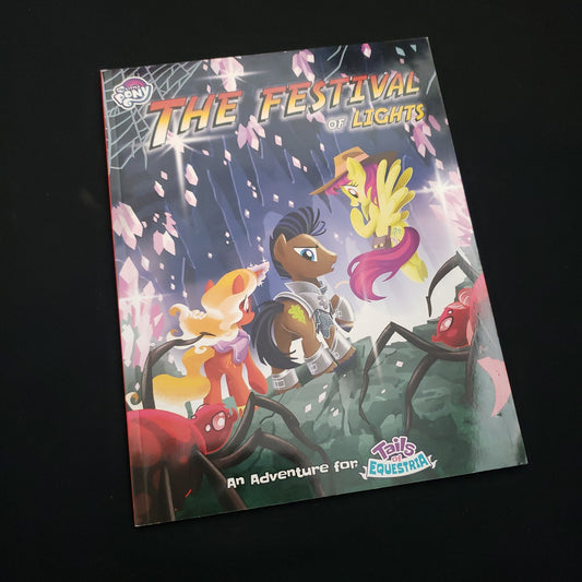 Image shows the front cover of the Festival of Lights book for the My Little Pony: Tales of Equestria roleplaying game