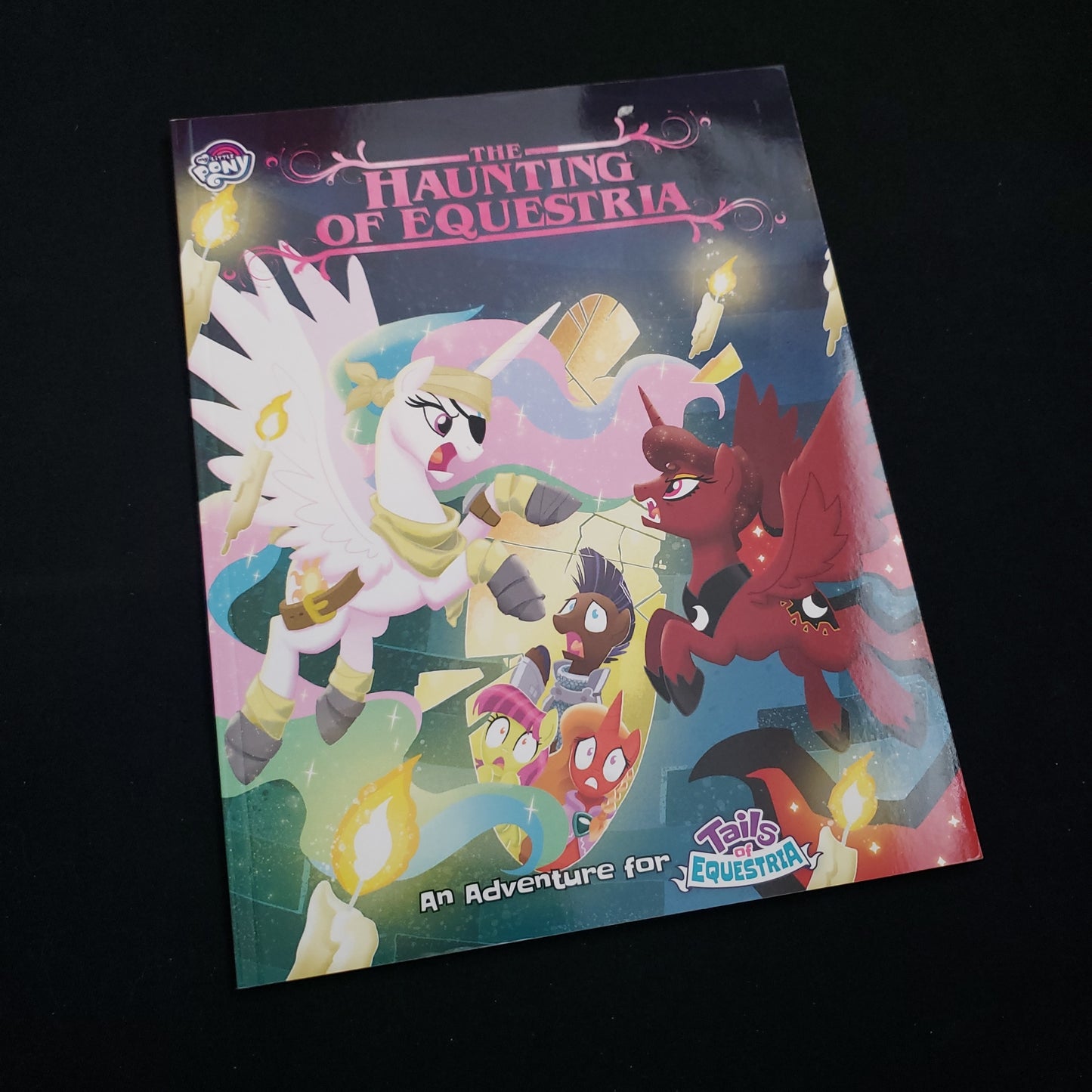 Image shows the front cover of the Haunting of Equestria book for the My Little Pony: Tales of Equestria roleplaying game