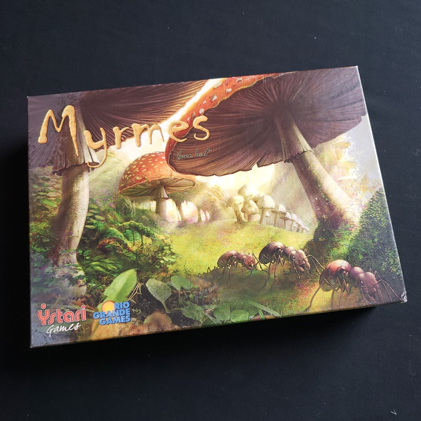 Image shows the front cover of the box of the Myrmes board game