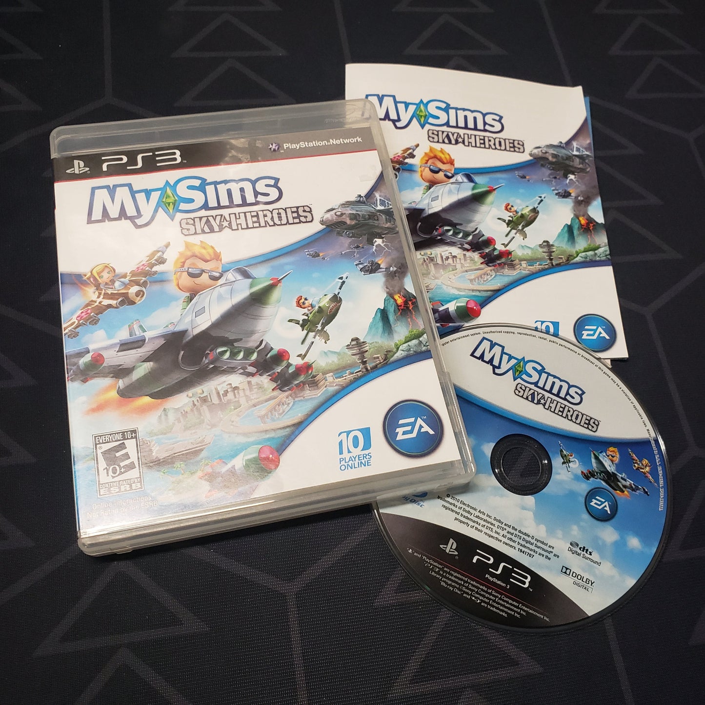 Image shows the case, manual and disc for the video game MySims: Sky Heroes for Playstation 3