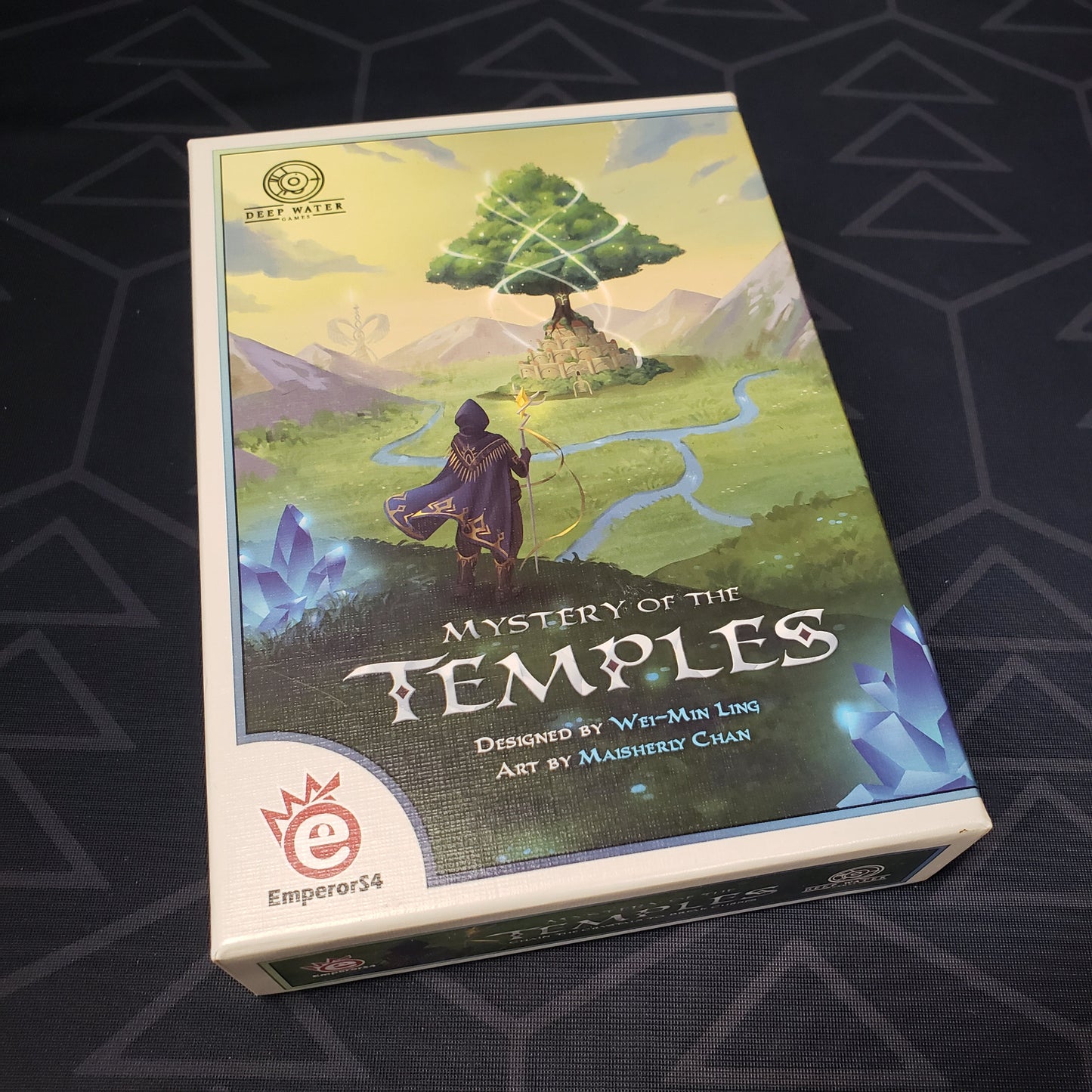 Image shows the front cover of the box of the Mystery of the Temples card game