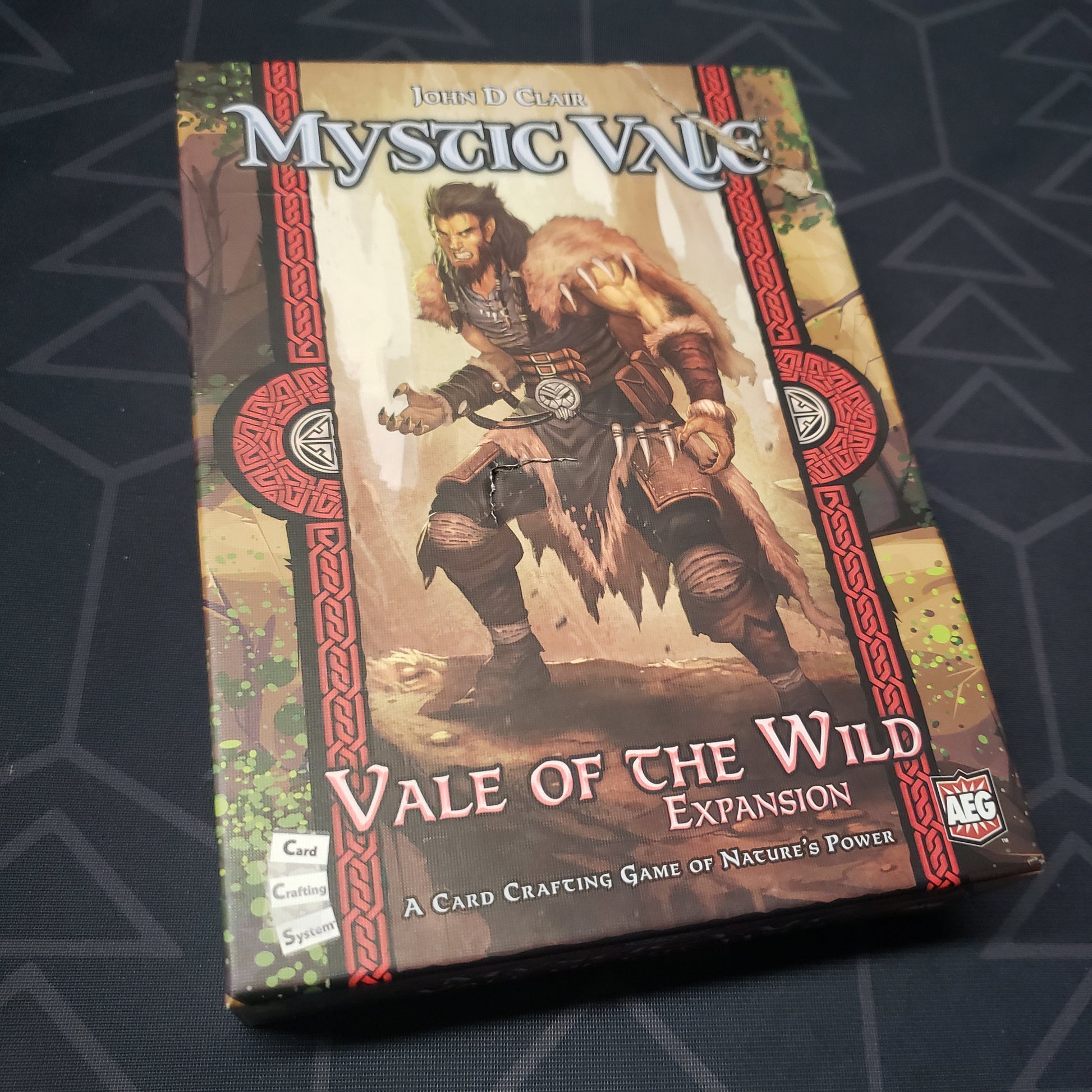Image shows the front cover of the box of the Vale of the Wild expansion for the card game Mystic Vale