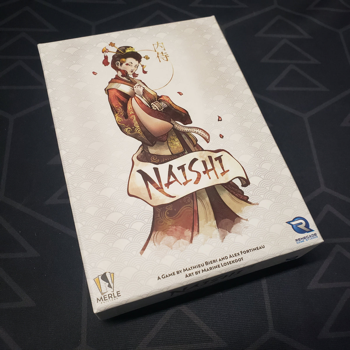 Image shows the front cover of the box for the Naishi card game
